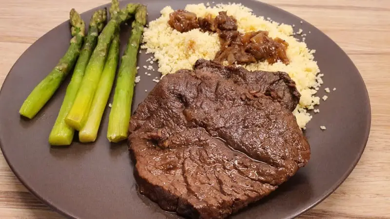 Dutch oven braised sliced beef with couscous and asparagus