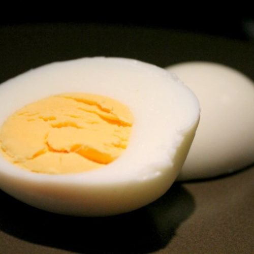 Hard boiled egg on brown plate