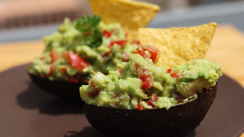 Guacamole in avocado with tortilla chips