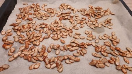 Pumpkin seeds with spices on a baking tray