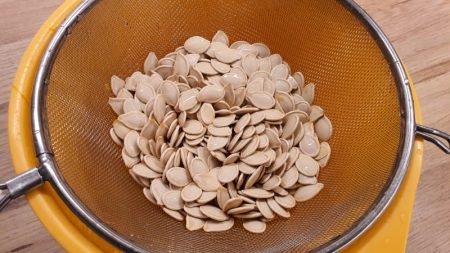Washing pumpkin seeds in a colander