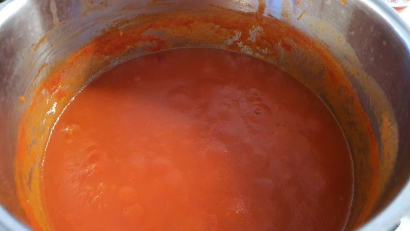 Caramelized tomato on the side of the saucepan