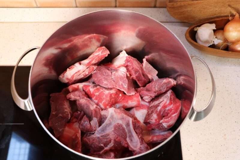 Beef meat and bones in pot